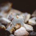 GOAT Pendant with a red collar, covered in corresponding colored CZ stones, pictured on a rocky landscape.
