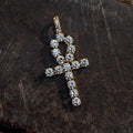 . 3/4 Inch Ankh Cross made up of large CZ stones and yellow gold plated lying flat on a black surface.