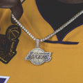 LA Lakers Pendant covered in corresponding color CZ stones, on a matching 20” 3mm Tennis Chain in yellow gold, worn by a male model in a LA Lakers Jersey.